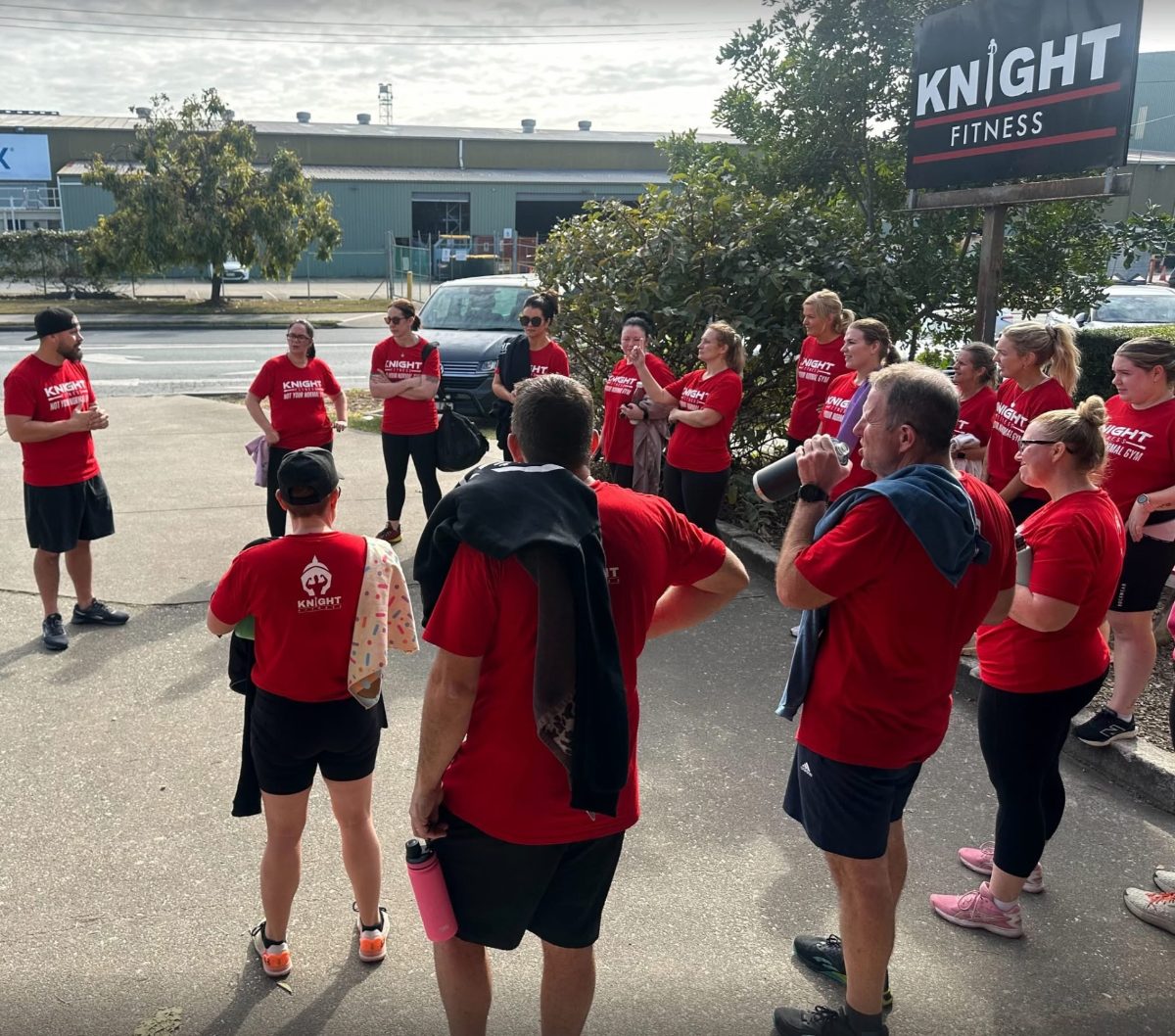 Knight Fitness crew in red shirts outside the gym