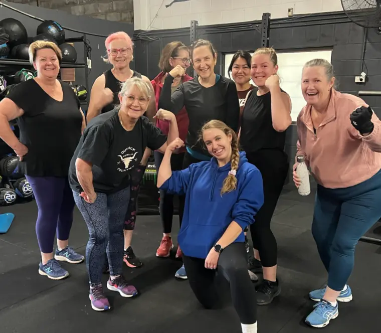 Women's Club members of all ages flexing together after a session